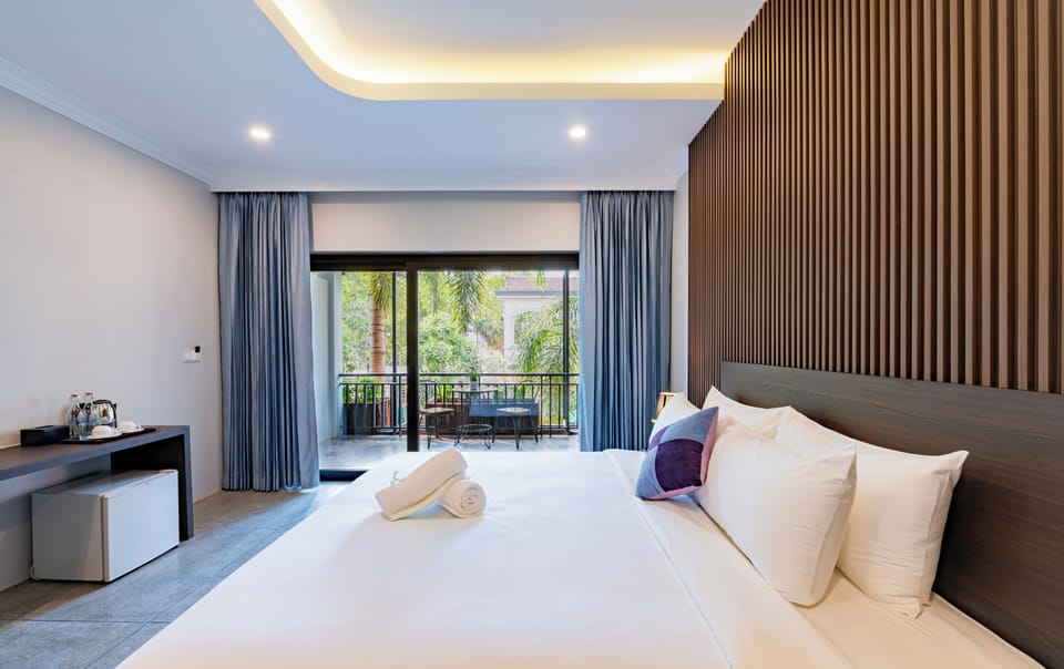Deluxe Double Room, Pool View | Down comforters, in-room safe, individually decorated, desk