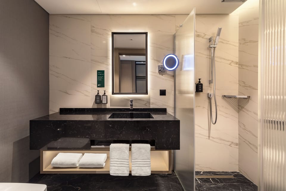 Shower, designer toiletries, hair dryer, bathrobes