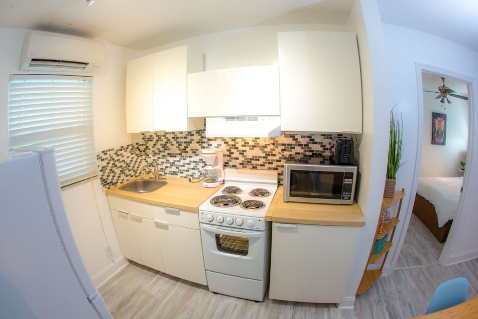 Grand Suite, 1 Bedroom | Private kitchen | Full-size fridge, microwave, stovetop, coffee/tea maker