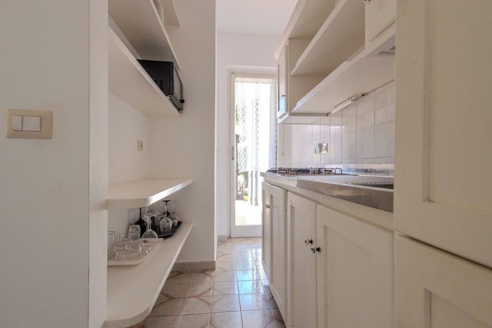 Full-size fridge, microwave, stovetop, cookware/dishes/utensils