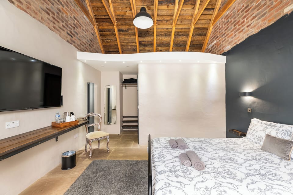Superior Double Room, Courtyard View | Desk, laptop workspace, blackout drapes, iron/ironing board