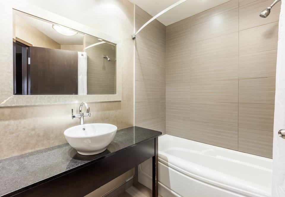 Economy Room, 2 Queen Beds | Bathroom | Combined shower/tub, eco-friendly toiletries, hair dryer, towels