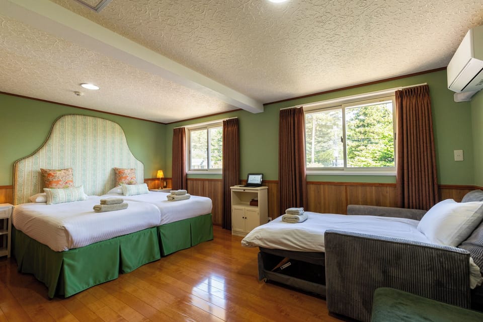 Premium bedding, desk, laptop workspace, blackout drapes