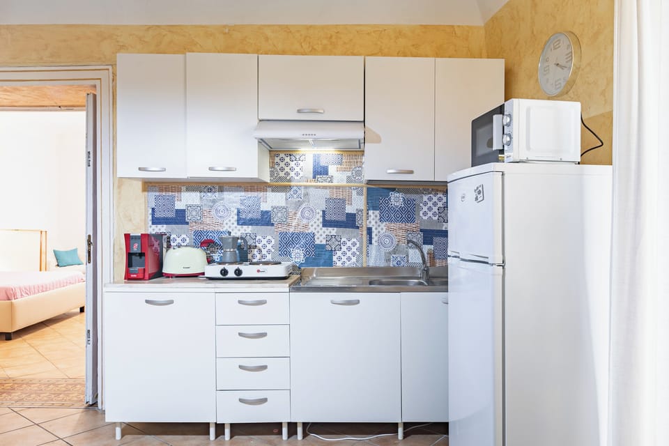 Apartment | Private kitchen | Full-size fridge, microwave, stovetop, cookware/dishes/utensils