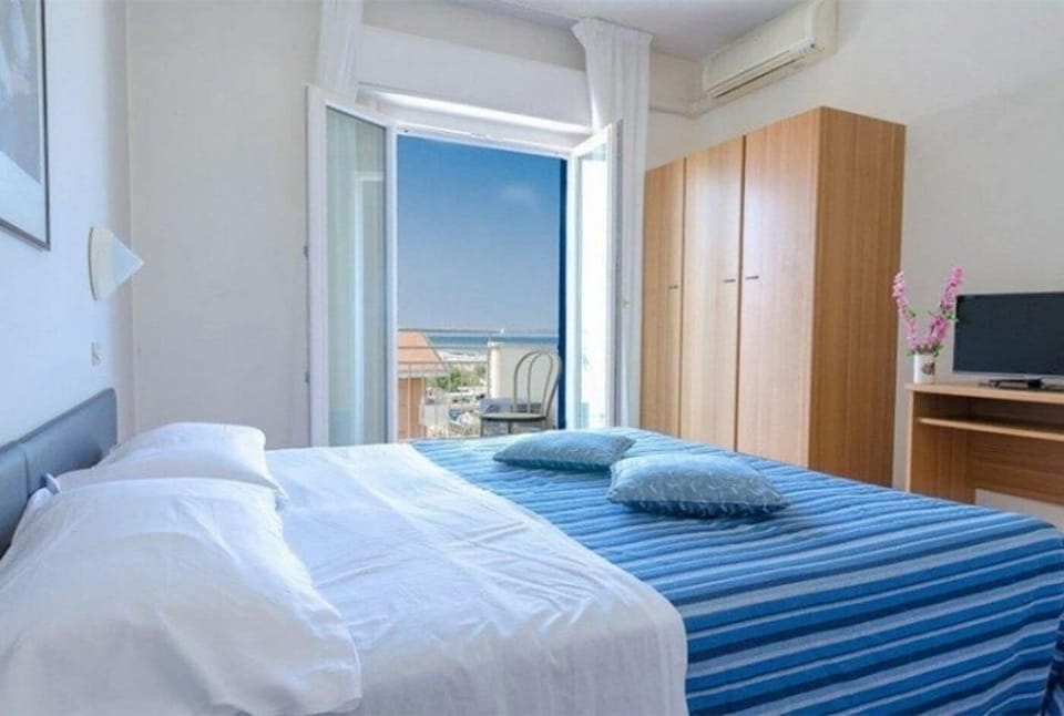 Standard Quadruple Room, Balcony, Partial Sea View | In-room safe, desk, free WiFi