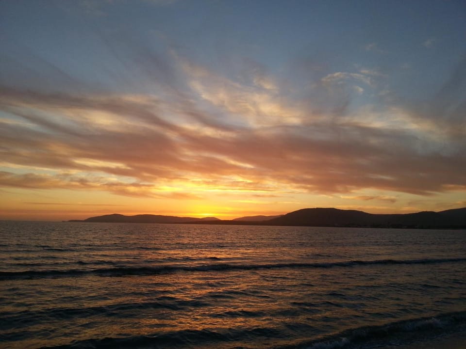 Beach nearby, white sand, beach umbrellas, beach towels