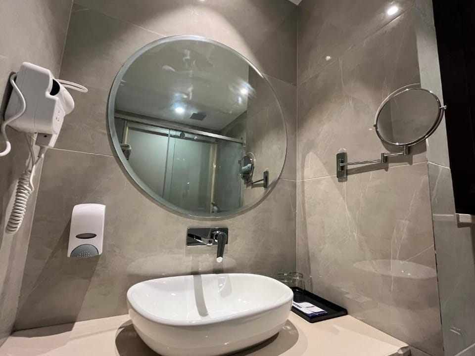 Shower, hair dryer, slippers, towels