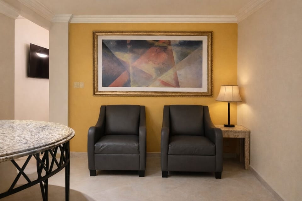 Deluxe Room | Living area | 55-inch Smart TV with cable channels