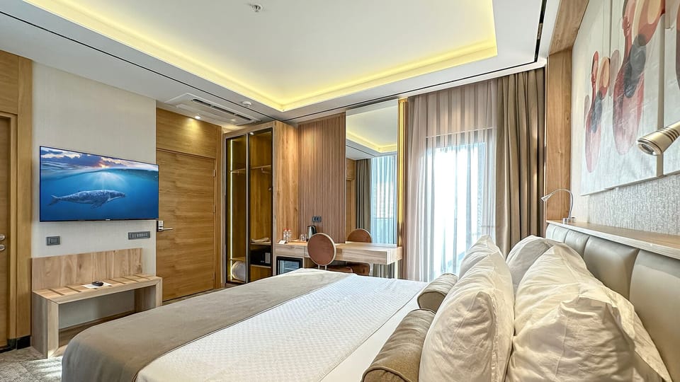 Standard Double Room, Balcony, Partial Sea View | In-room safe, desk, laptop workspace, blackout drapes