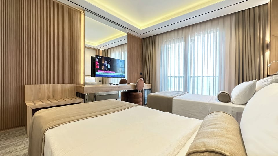 Standard Twin Room, Balcony, Partial Sea View | In-room safe, desk, laptop workspace, blackout drapes