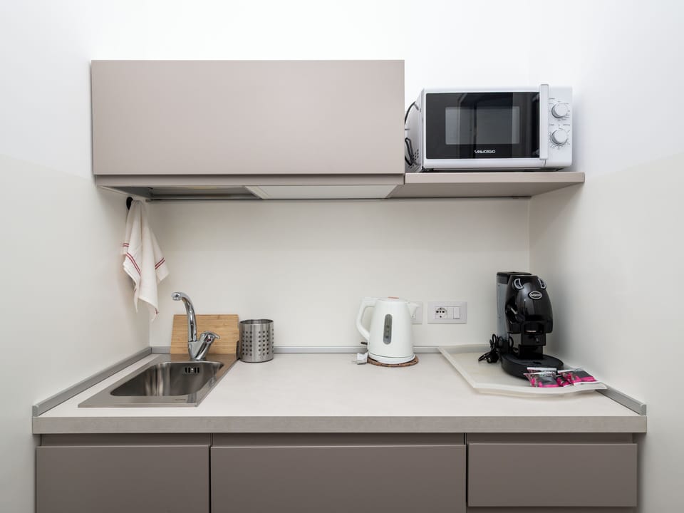 Design Apartment, Balcony, City View | Private kitchen | Mini-fridge, microwave, espresso maker, electric kettle