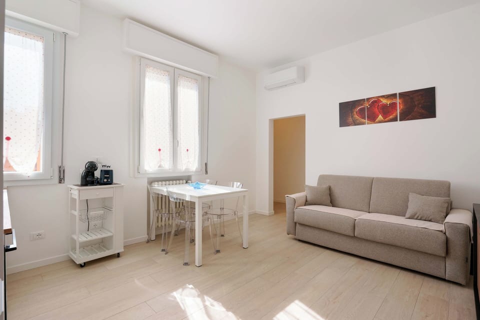 Apartment (Bilocale via cignani) | Living area | 43-inch flat-screen TV with cable channels