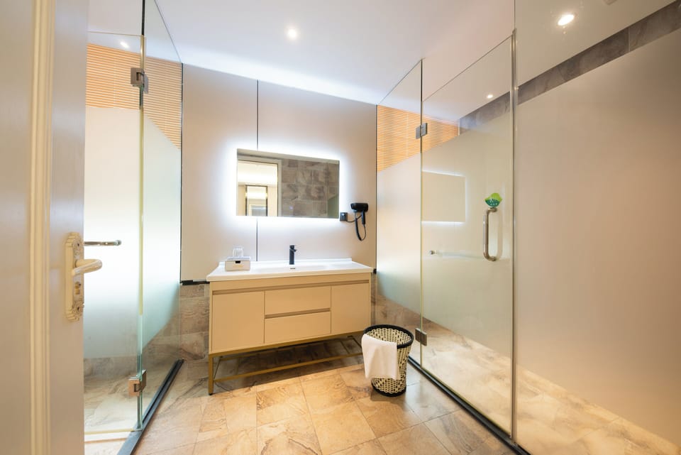 Shower, hair dryer, slippers, towels