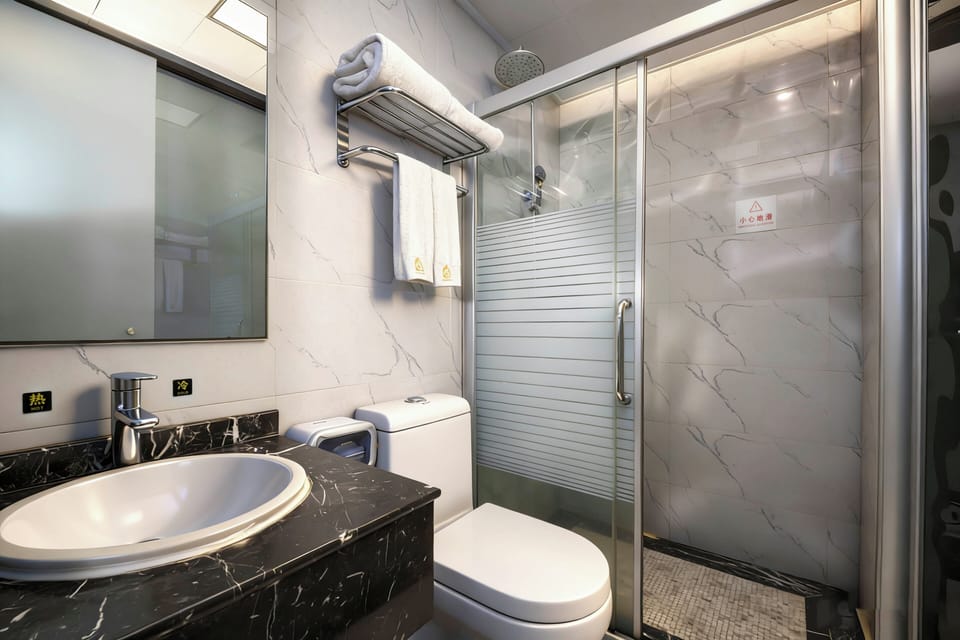 Shower, hair dryer, slippers, towels