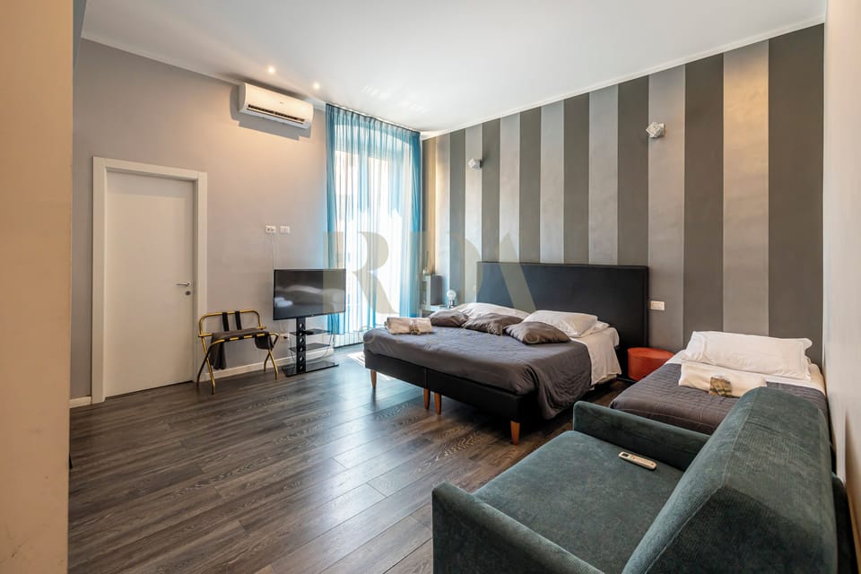 Deluxe Quadruple Room | In-room safe, individually decorated, individually furnished, desk