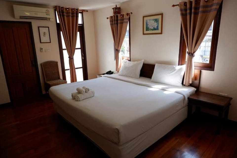 Standard King Bed Room with Window and Balcony at the Corner | In-room safe, blackout drapes, rollaway beds, free WiFi