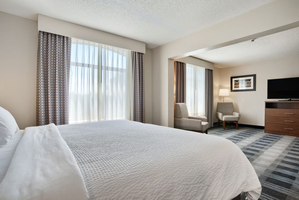 Suite, 1 King Bed (Extra Floor Space) | Desk, laptop workspace, blackout drapes, iron/ironing board