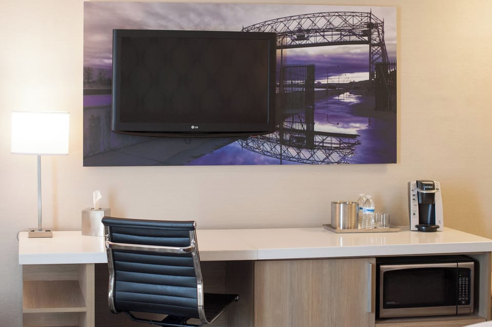 Premium bedding, desk, laptop workspace, blackout drapes