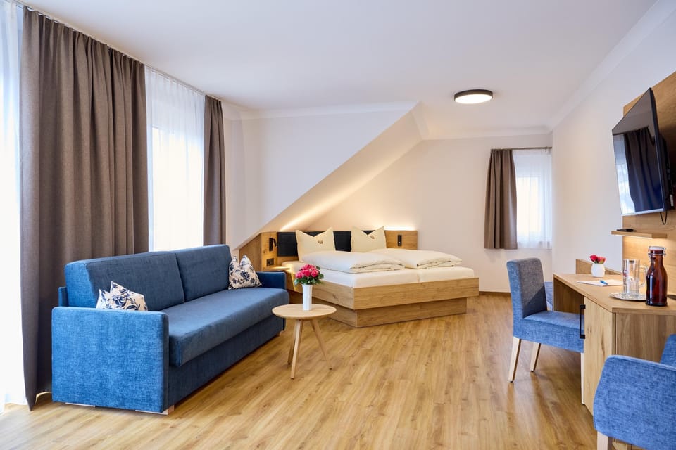 Superior Triple Room | Living area | 25-inch flat-screen TV with satellite channels