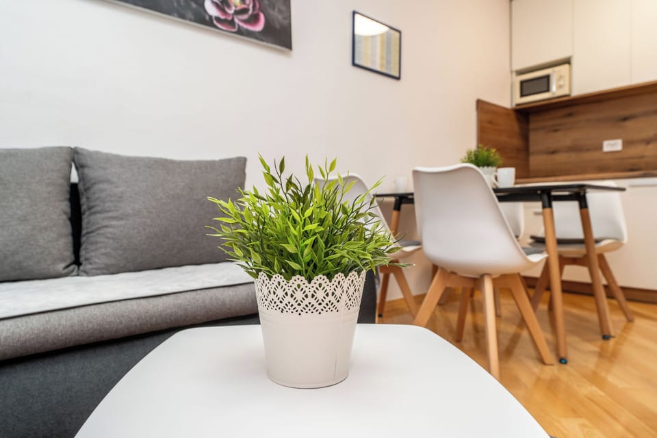 Standard Apartment, Garden View | Living area | 100-cm Smart TV with cable channels