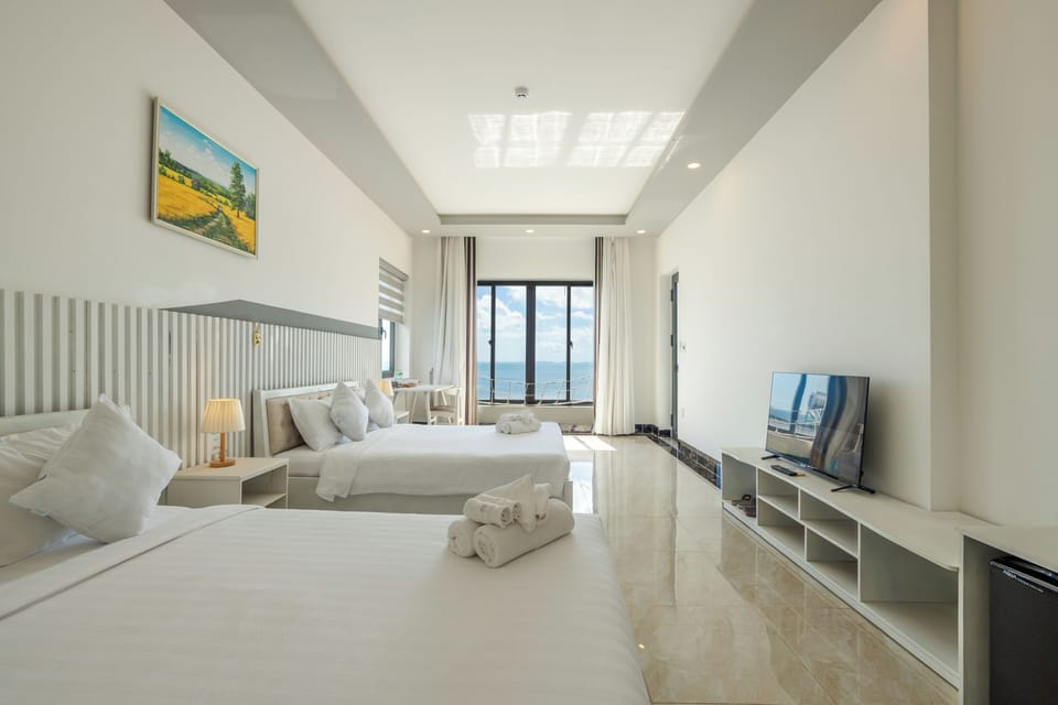 Deluxe Quadruple Room, 2 Double Beds, Sea View | In-room safe, desk, laptop workspace, blackout drapes