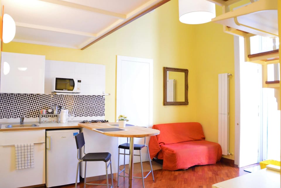 Deluxe Duplex, Balcony | Living area | 32-inch flat-screen TV with satellite channels, TV