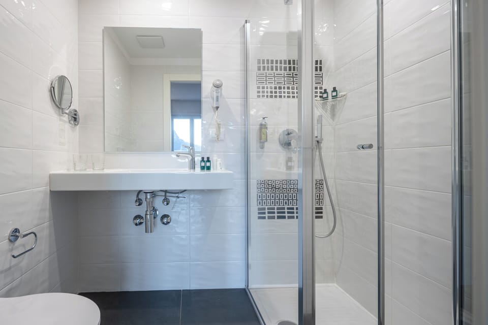 Deluxe Triple Room, Balcony, Garden View | Bathroom | Shower, hair dryer, towels, soap