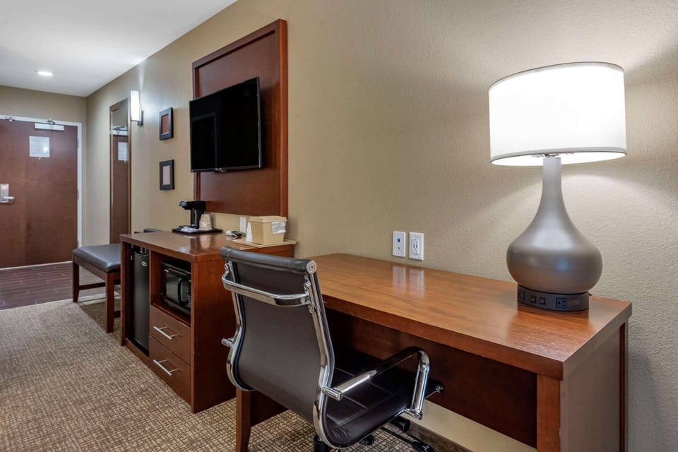 Hypo-allergenic bedding, desk, laptop workspace, blackout drapes