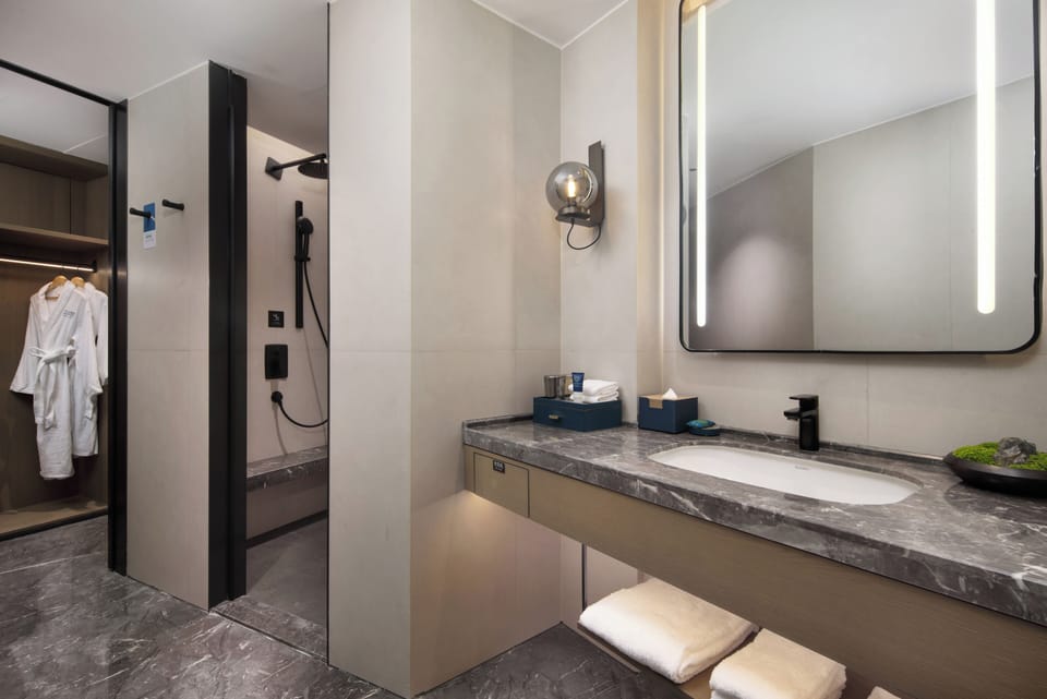 Family Studio Suite, Garden View | Bathroom | Shower, hair dryer, slippers, towels