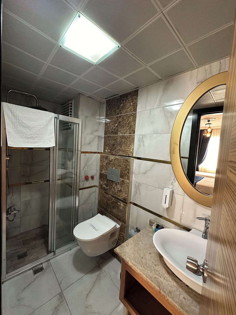 Shower, hair dryer, slippers, towels