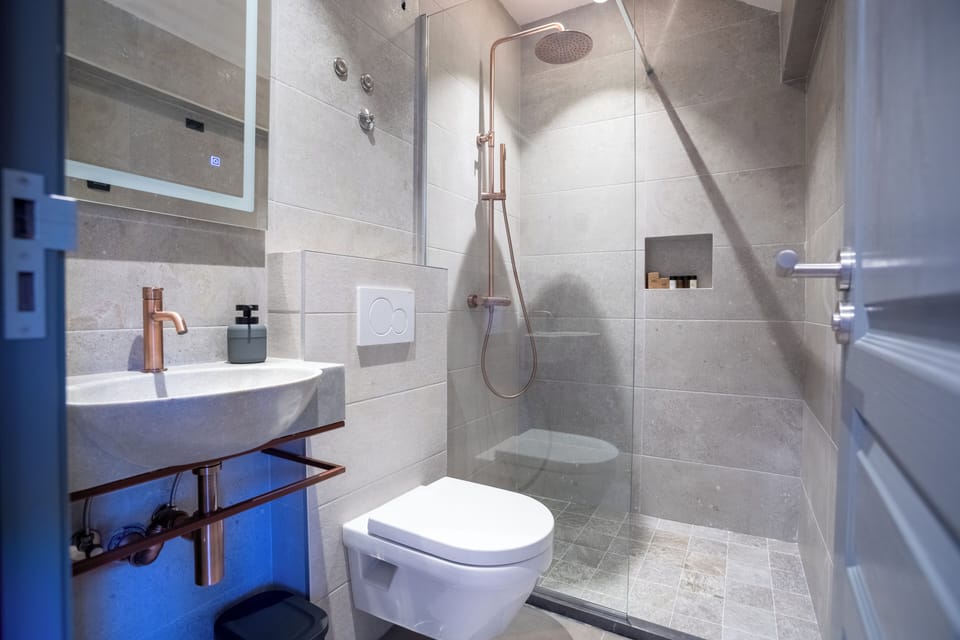 Shower, hair dryer, slippers, towels