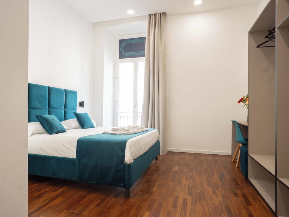 Family Quadruple Room, City View | In-room safe, desk, laptop workspace, blackout drapes