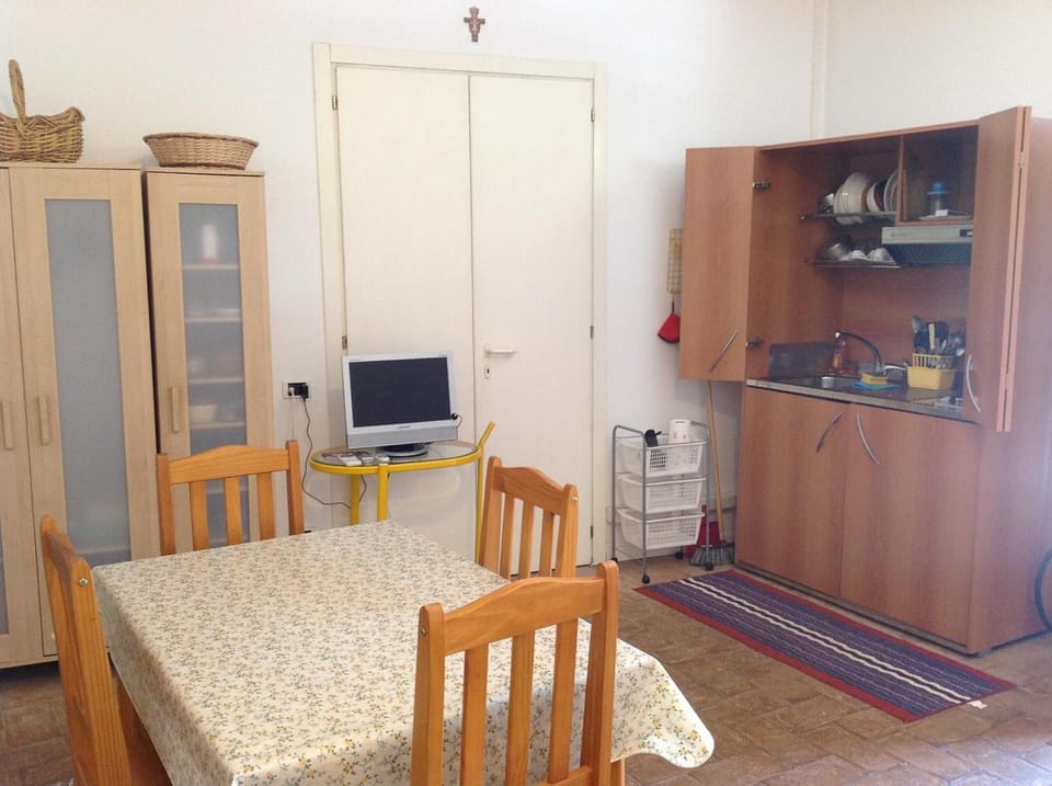 Full-size fridge, highchair, cookware/dishes/utensils, cleaning supplies