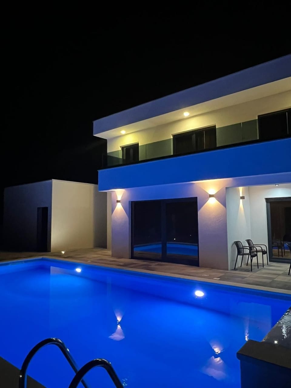 Outdoor pool, a heated pool, open open 24 hours, pool umbrellas
