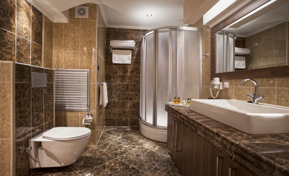 Shower, hair dryer, slippers, towels