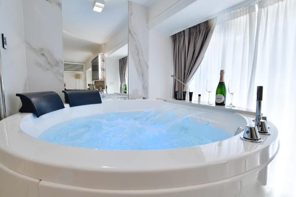 Exclusive Suite, 1 King Bed, Non Smoking, City View | Bathroom | Hair dryer, slippers, towels, soap
