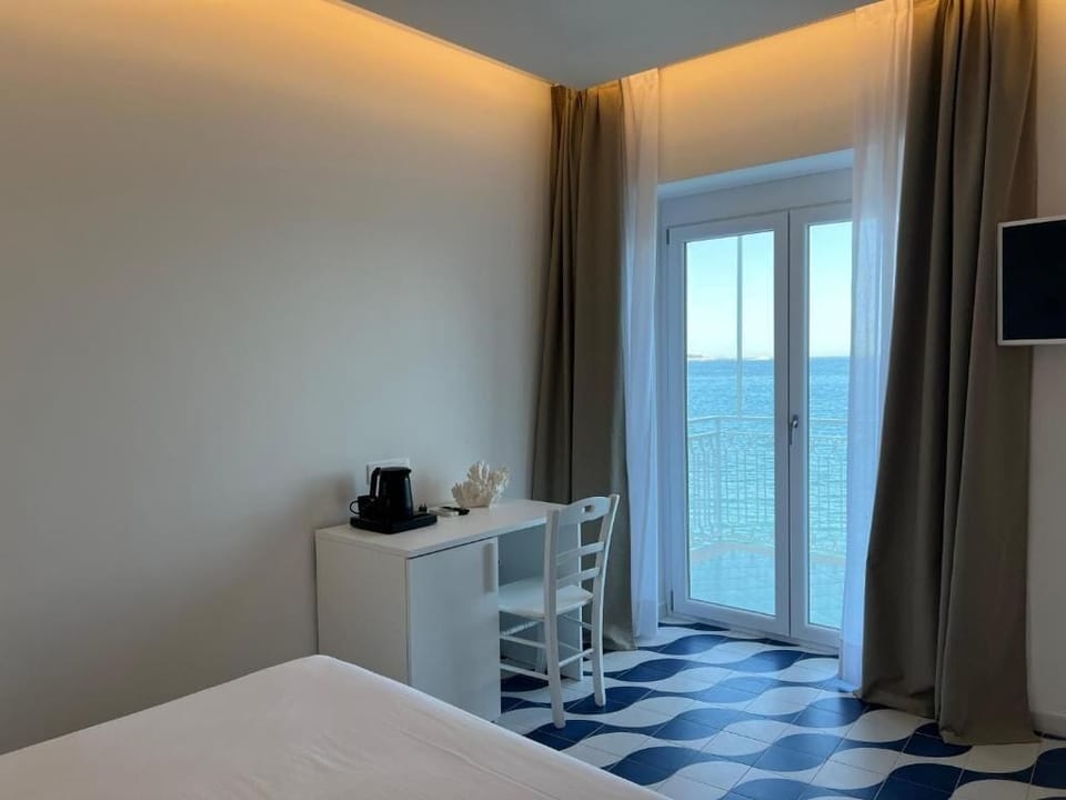 Deluxe Room, Sea View | In-room safe, blackout drapes, iron/ironing board (on request)