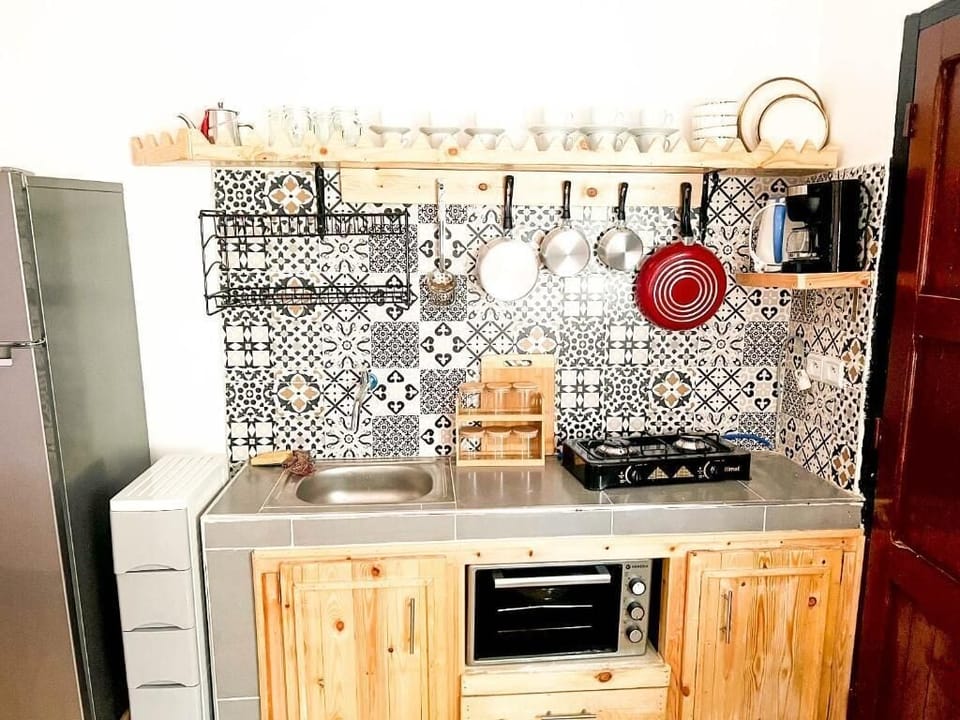 Family Studio, Partial Sea View | Private kitchen | Fridge, cookware/dishes/utensils, cleaning supplies, dining tables