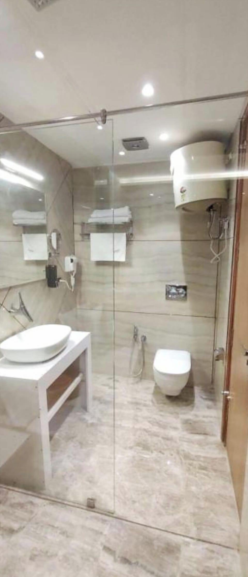 Shower, rainfall showerhead, slippers, towels