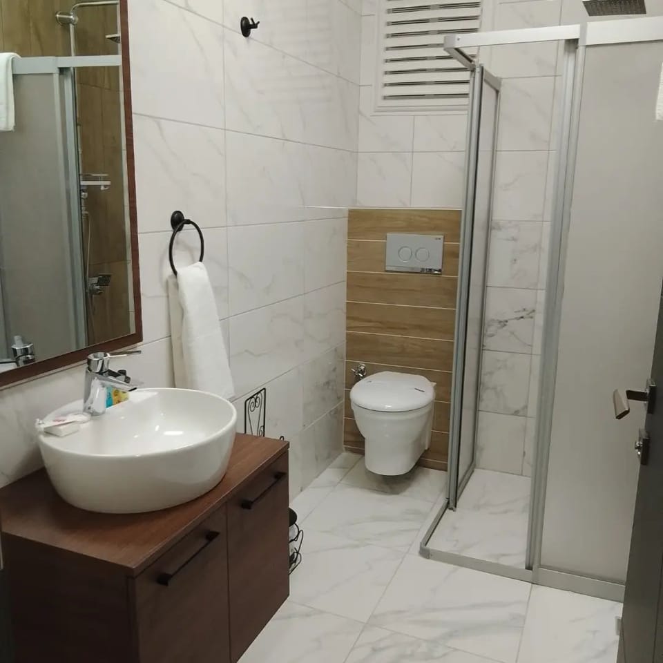 Deluxe Room, Balcony, City View | Bathroom | Shower, slippers, towels, soap