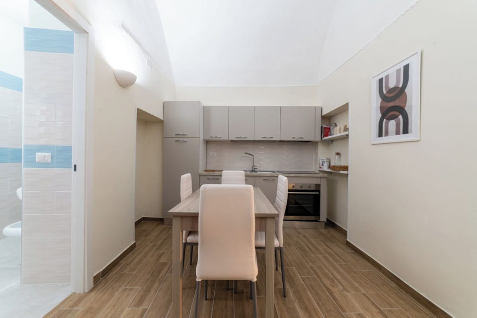 Apartment (1 Bedroom) | Private kitchen | Stovetop, cookware/dishes/utensils, dining table