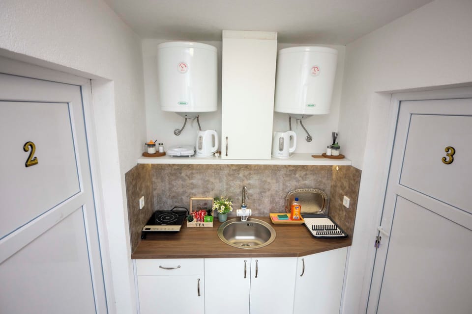 Fridge, stovetop, electric kettle, cookware/dishes/utensils