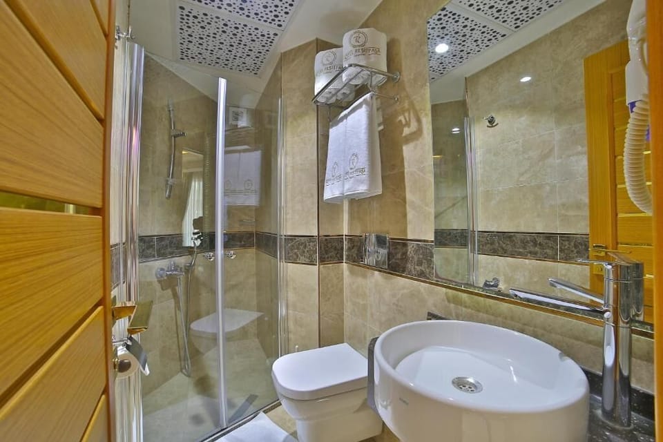 Shower, hair dryer, slippers, towels