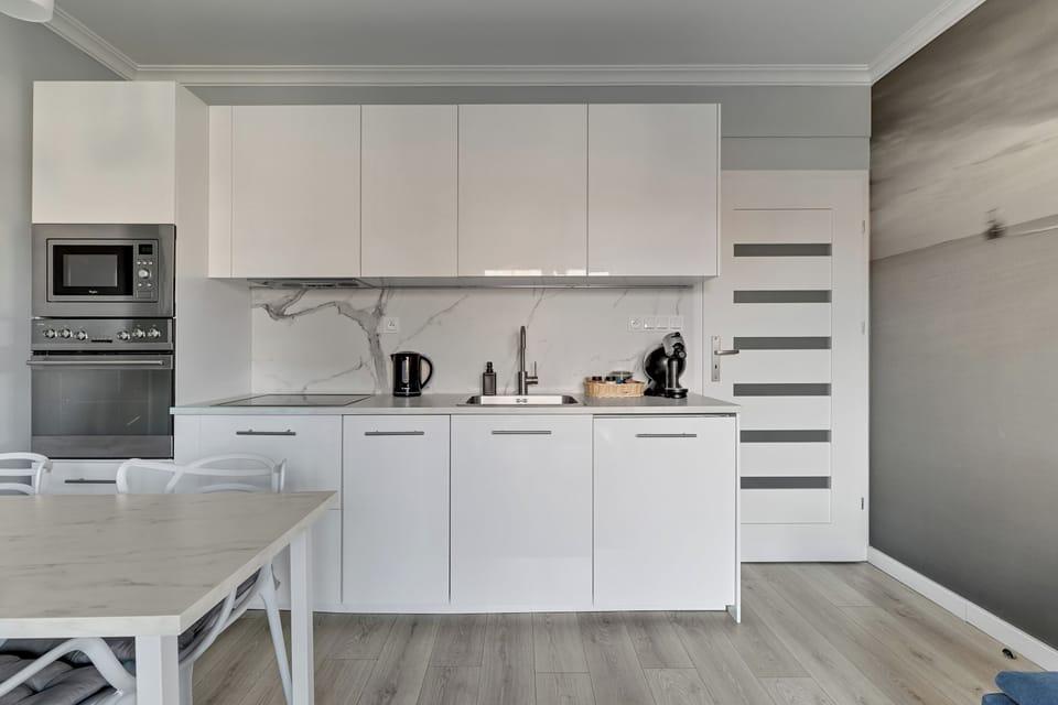Family Apartment, City View | Private kitchen | Highchair, freezer, paper towels