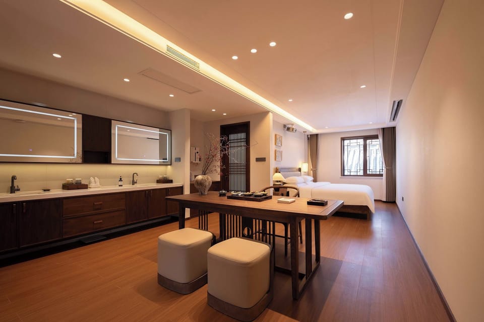 Luxury Suite, Garden View | Minibar, desk, laptop workspace, blackout drapes