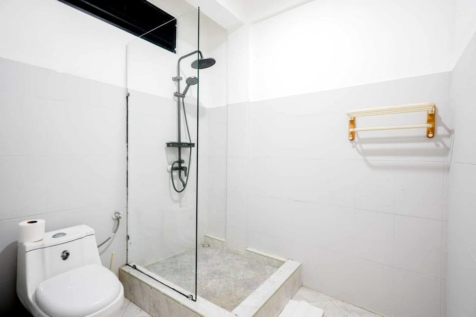 Shower, slippers, towels, toilet paper