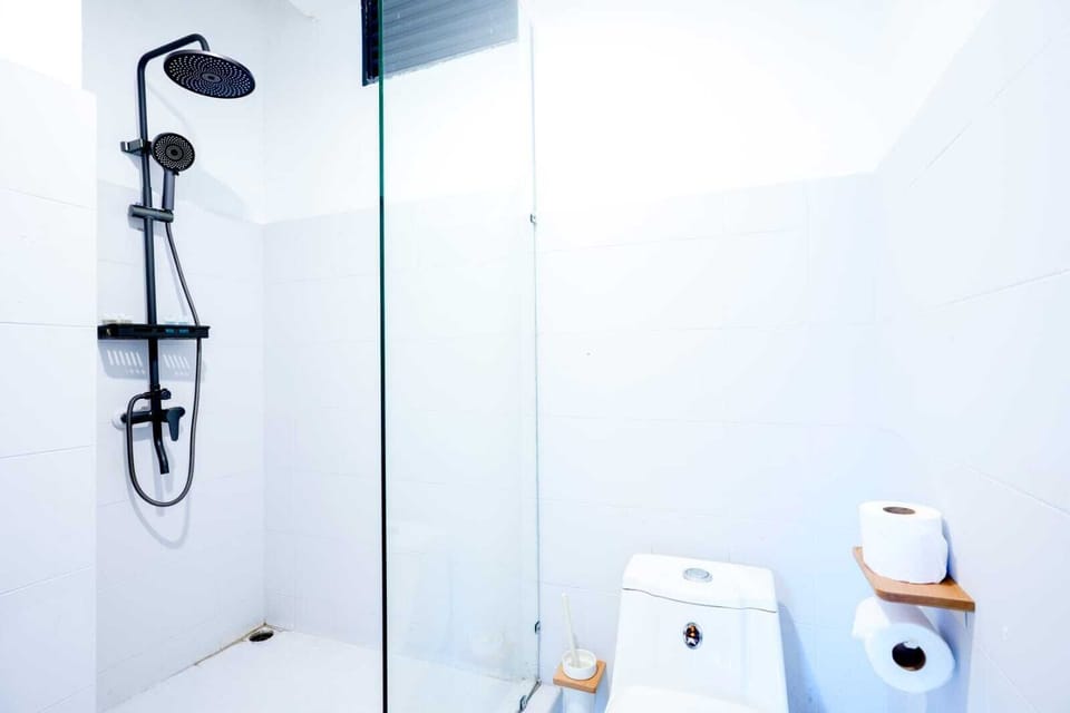 Shower, slippers, towels, toilet paper