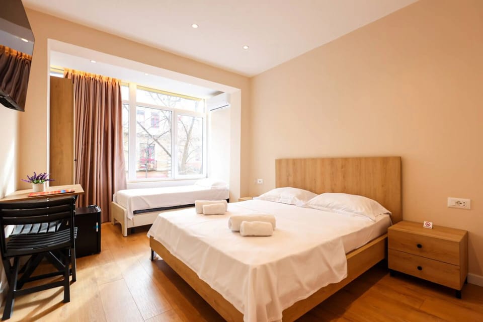 Deluxe Triple Room, City View | Desk, laptop workspace, WiFi (free), bed sheets