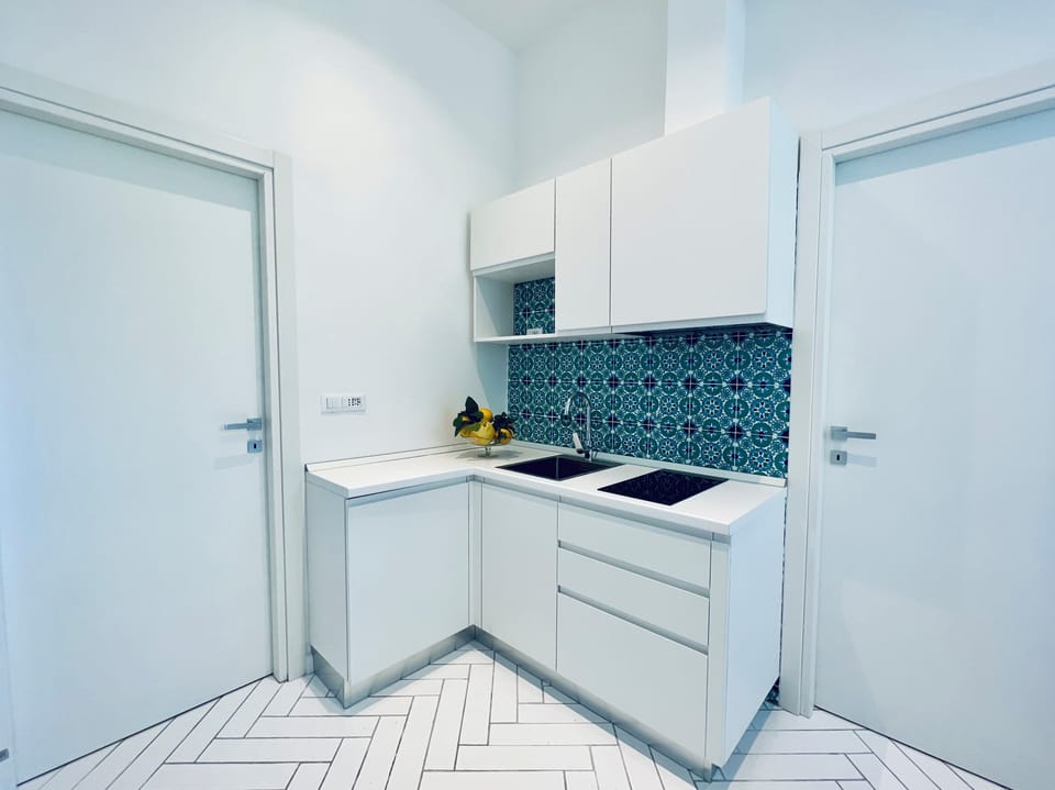 Apartment, Balcony, Partial Sea View | Private kitchen | Microwave, stovetop, espresso maker, electric kettle