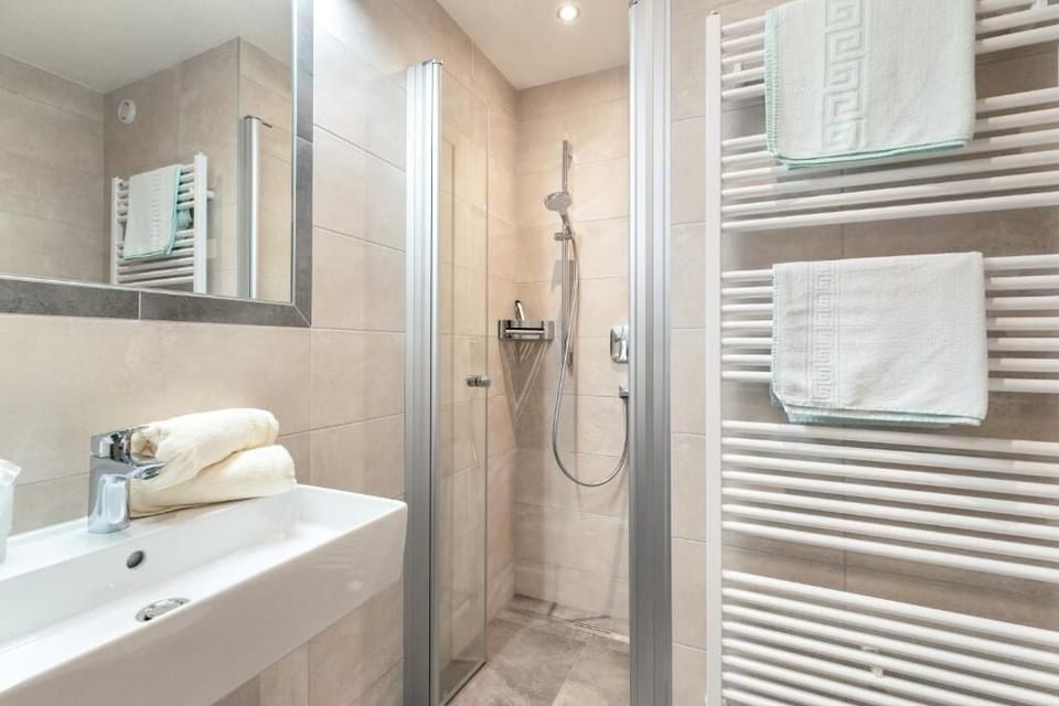 Shower, hair dryer, towels, toilet paper